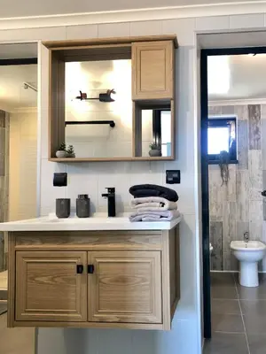 a bathroom with a sink and a mirror at Drive Point (Adventure Lake Resort) in Asparukhovo