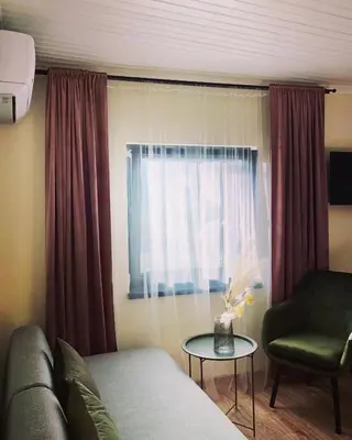 a living room with a couch and a chair and a window at Drive Point (Adventure Lake Resort) in Asparukhovo