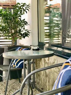a table and chairs in a room with a window at Drive Point (Adventure Lake Resort) in Asparukhovo
