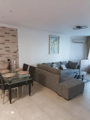 a living room with a couch and a table at Monastery II Garden stay like home in Sveti Vlas