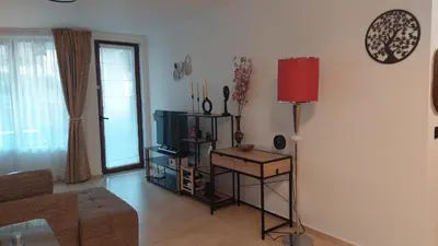 a living room with a couch and a tv at Monastery II Garden stay like home in Sveti Vlas