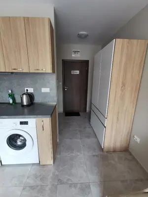 a kitchen with a washing machine and a refrigerator at Admiral Plaza Sunrise Apartments C13 in Sunny Beach