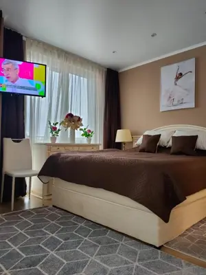 a bedroom with a bed and a flat screen tv at Afrodita Palas , studio appartment 4 floor, pool view in Sunny Beach