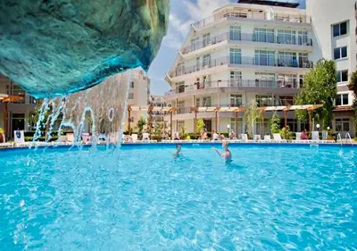 three people in a swimming pool in a building at Charming 2-bed flat with pool view in Sunny Beach, Bulgaria in Sunny Beach