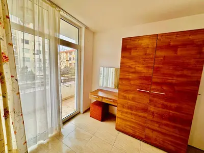 a room with a wooden door and a window at Charming 2-bed flat with pool view in Sunny Beach, Bulgaria in Sunny Beach