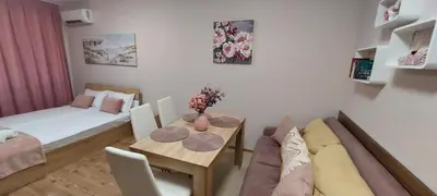 a living room with a couch and a table at Студио Ервина in Ravda