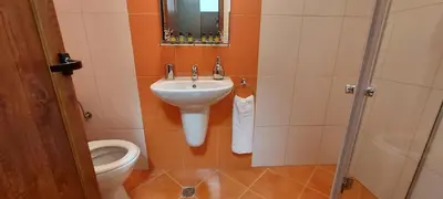 a bathroom with a sink and a toilet at Студио Ервина in Ravda
