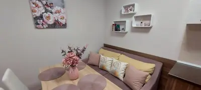 a living room with a couch and a table at Студио Ервина in Ravda
