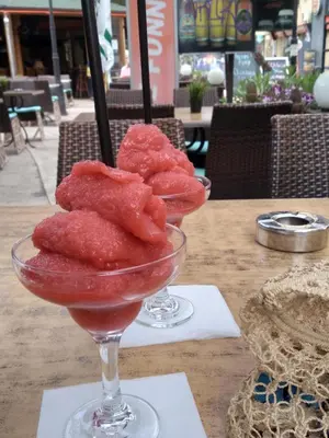 two wine glasses filled with fruit on a table at Sunny beach apartaments in Sunny Beach