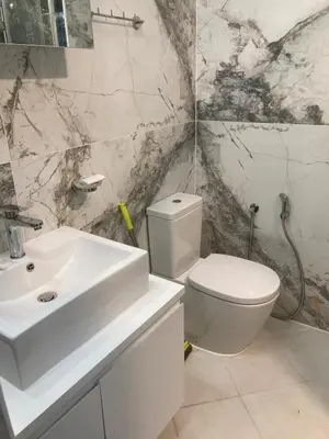 a bathroom with a white sink and a toilet at Studio 
