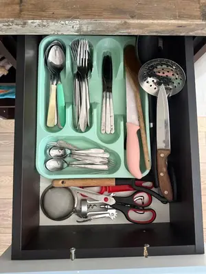 a drawer filled with utensils in a black box at Studio 