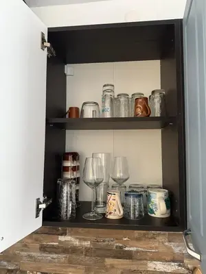 a cabinet filled with glasses and wine glasses at Studio 