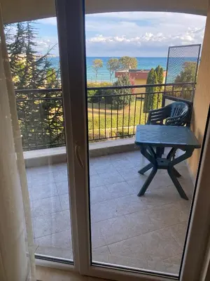 a balcony with a bench and a view of the ocean at Midia Family Resort, Aheloy in Aheloy