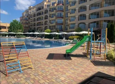 a swimming pool with a slide and a playground at Midia Family Resort, Aheloy in Aheloy
