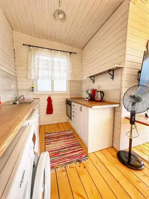 a kitchen with a counter and a table in a room at каравани Дрийм Арапя in Tsarevo
