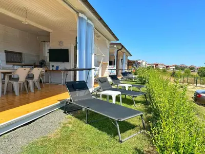a group of chairs sitting on a patio with a television at каравани Дрийм Арапя in Tsarevo