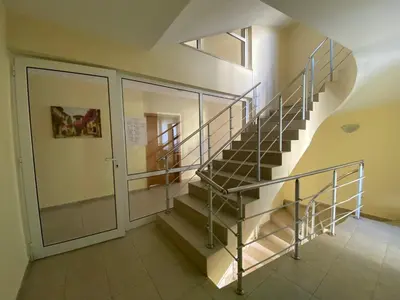 a staircase in a building with a metal railing at VECHNA R 18 Studio Sunny Beach in Sunny Beach
