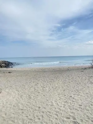 a sandy beach with the ocean in the background at Sea View Apartment with Free Parking in Pomorie