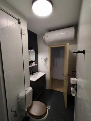 a bathroom with a toilet and a sink and a shower at Apartment Daisy Grand Kamelia in Sunny Beach