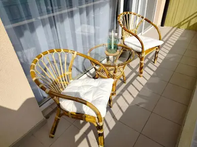 two chairs and a table on a balcony at Apartment Daisy Grand Kamelia in Sunny Beach