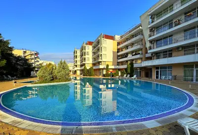 a large swimming pool in the middle of a building at Apartment Daisy Grand Kamelia in Sunny Beach