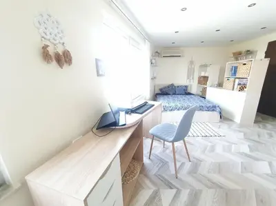a small bedroom with a desk and a bed at Sunset Dreams apartment in Burgas City