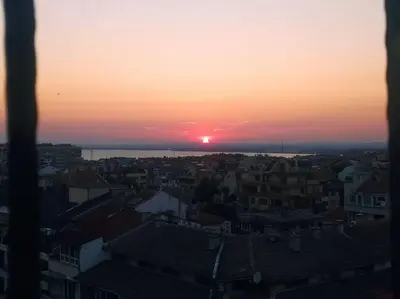 a sunset over a city with houses and buildings at Sunset Dreams apartment in Burgas City