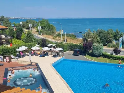 a pool at a resort with a view of the ocean at Eve Santa Marina Apartments II - sea, pools, relax in Sozopol