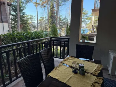 a table and chairs on the balcony of a house at Eve Santa Marina Apartments II - sea, pools, relax in Sozopol