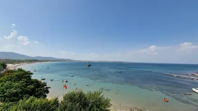 a beach with a bunch of people in the water at Eve Santa Marina Apartments II - sea, pools, relax in Sozopol