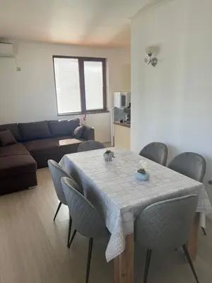 a living room with a table with chairs and a couch at Частен апартамент Стамополу - Private Two-Bedroom Apartment Stamopolu in Primorsko