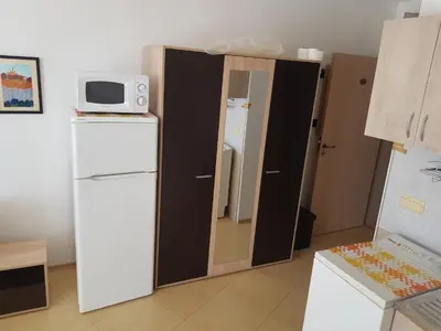 a kitchen with a refrigerator and a microwave at Midia Grand Rezort in Aheloy