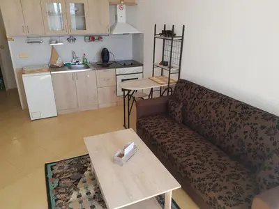 a living room with a couch and a table at Midia Grand Rezort in Aheloy