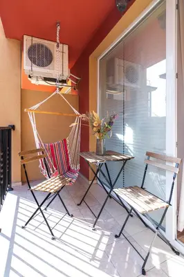 two chairs and a hammock on a porch at Todorka Sunny View Central w Słonecznym Brzegu in Sunny Beach
