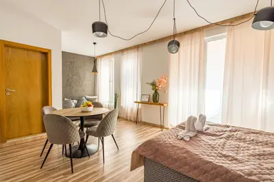 a bedroom with a bed and a table and chairs at Todorka Sunny View Central w Słonecznym Brzegu in Sunny Beach
