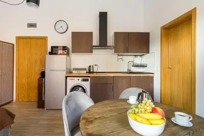 a kitchen with a table with a bowl of fruit on it at Todorka Sunny View Central w Słonecznym Brzegu in Sunny Beach