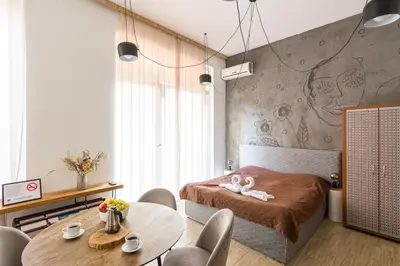 a bedroom with a bed and a table and chairs at Todorka Sunny View Central w Słonecznym Brzegu in Sunny Beach