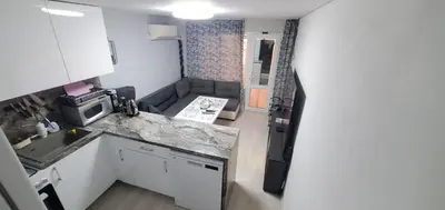 a small kitchen with white cabinets and a sink at DELUXE TOP CENTER House with garden's tent ,2 bedrooms and living room next to the BEACH and SEA GARDEN- 5 min by walk,with equiped kitchen in Burgas City