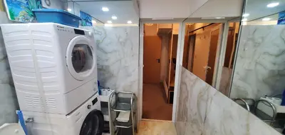 a washing machine in a bathroom with a mirror at DELUXE TOP CENTER House with garden's tent ,2 bedrooms and living room next to the BEACH and SEA GARDEN- 5 min by walk,with equiped kitchen in Burgas City