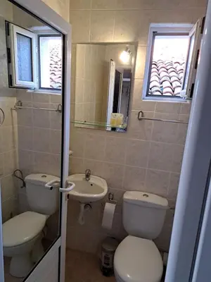 a bathroom with a toilet and a sink at The White House in Nesebar