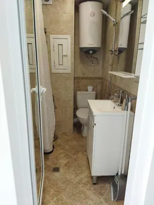 a small bathroom with a toilet and a sink at Сити бийч вю in Tsarevo