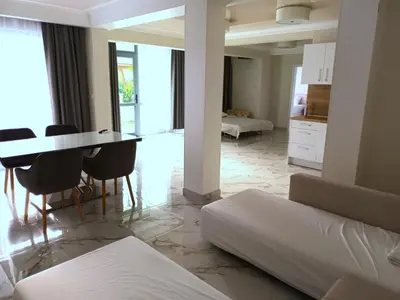 a bedroom with a bed and a table and chairs at Apartment Ground Floor in Pomorie
