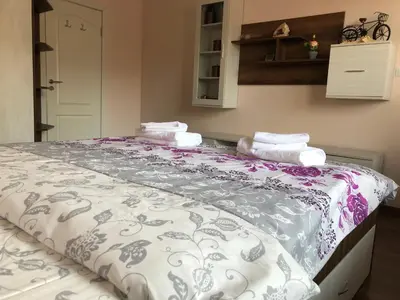 a large bed with towels on top of it at Purple Rose Apartment Valencia Gardens in Nesebar