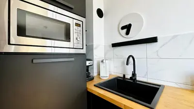 a kitchen with a sink and a microwave at ALEX BEACH Apartello·com - Amazing apartments with sea view! in Sveti Vlas