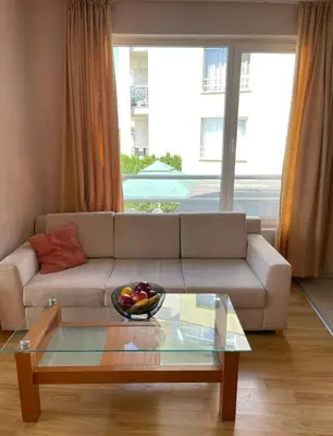 a living room with a couch and a bowl of fruit on a table at ALEX BEACH Apartello·com - Amazing apartments with sea view! in Sveti Vlas
