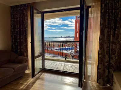 a room with a door open to a balcony at Luxurious 2 BR Appt at the Black Sea Coast in Sunny Beach