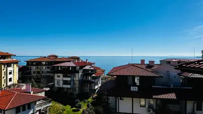 a group of buildings with the ocean in the background at ETARA 2, Sveti Vlas - APARTELLO⊛com in Sunny Beach