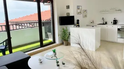 a living room with a table and a large window at ETARA 2, Sveti Vlas - APARTELLO⊛com in Sunny Beach