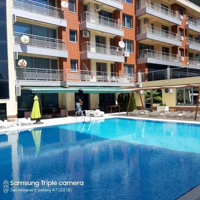 a large swimming pool in front of a building at Apartament Milenium in Pomorie