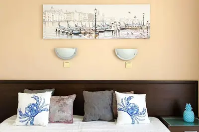 a bedroom with a bed with blue and white pillows at APARTELLO⊛com DIAMOND - private apartments near Marina Dinevi in Sveti Vlas in Sveti Vlas